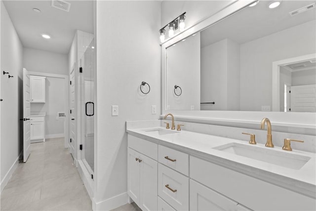 bathroom featuring vanity and an enclosed shower