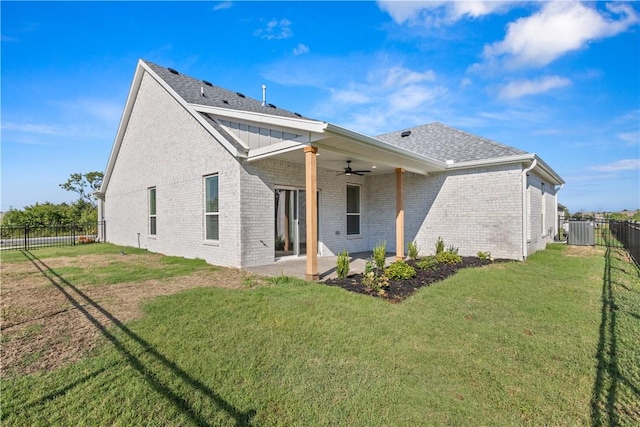 rear view of house featuring a yard, a patio area, and ceiling fan