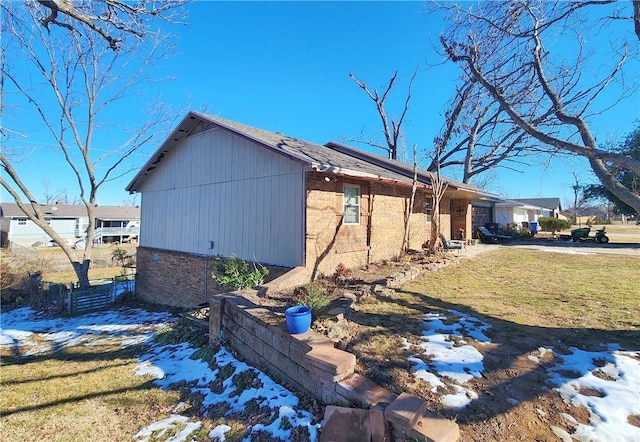 view of snowy exterior featuring a yard