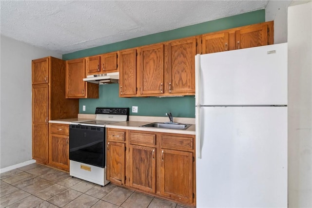 kitchen with white appliances, light tile patterned flooring, a textured ceiling, and sink