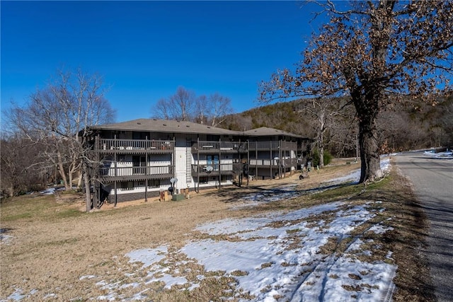 view of snow covered back of property