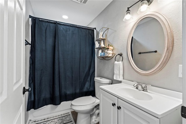 full bathroom featuring vanity, shower / bath combo with shower curtain, and toilet