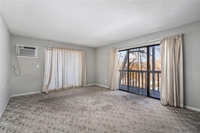 carpeted spare room featuring a textured ceiling and a wall mounted AC