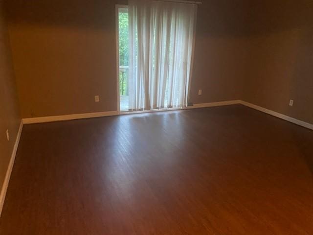 unfurnished room featuring wood-type flooring and plenty of natural light