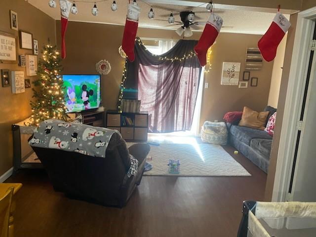 living room with ceiling fan and hardwood / wood-style flooring