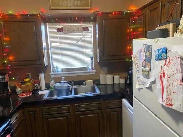 kitchen with sink and white fridge