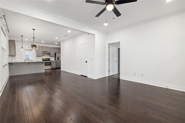 unfurnished living room featuring ceiling fan with notable chandelier, dark hardwood / wood-style flooring, and crown molding