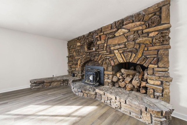 room details featuring hardwood / wood-style flooring and a wood stove