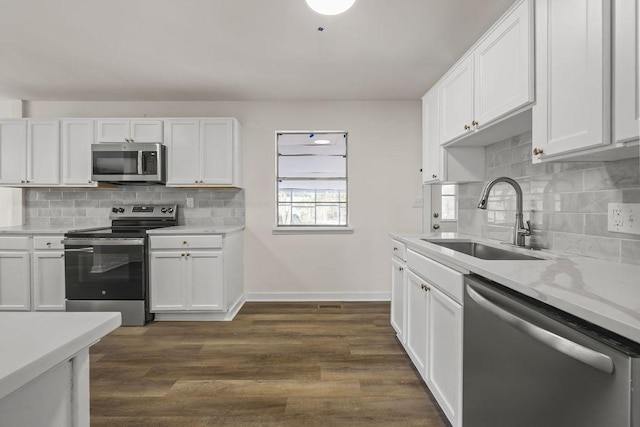 kitchen featuring sink, stainless steel appliances, and white cabinetry