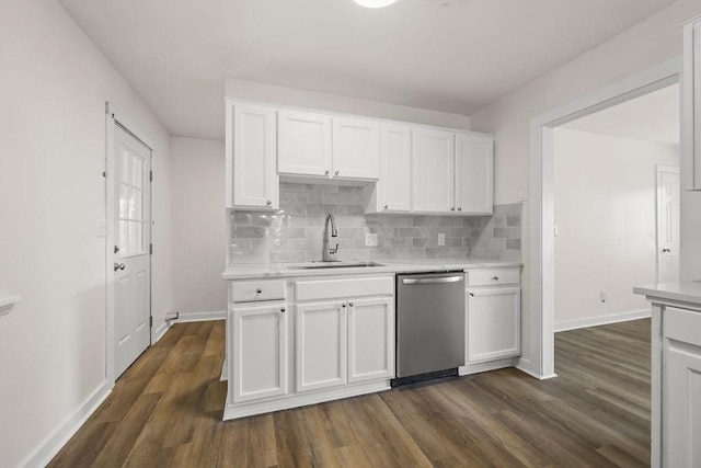 kitchen featuring stainless steel dishwasher, white cabinets, sink, and dark wood-type flooring