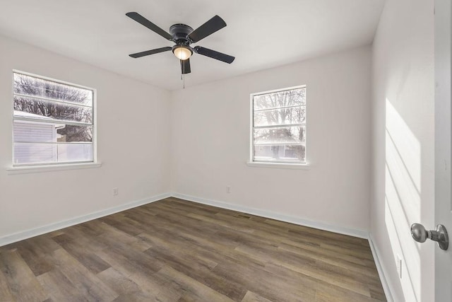 empty room with ceiling fan and dark wood-type flooring