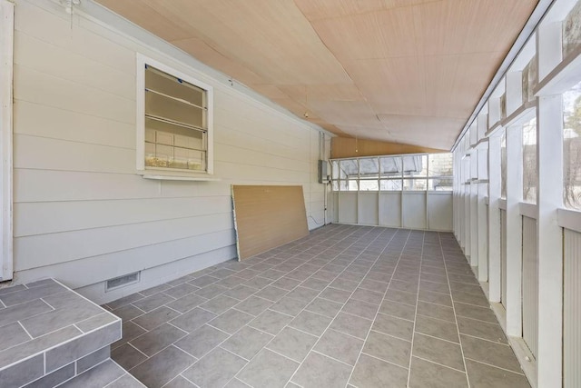 unfurnished sunroom featuring vaulted ceiling and wood ceiling