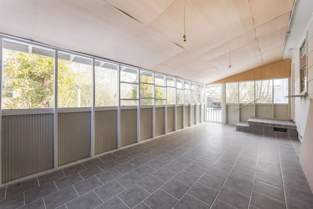 unfurnished sunroom featuring vaulted ceiling