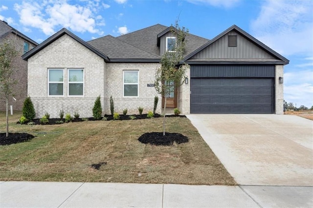 view of front of property with a garage and a front lawn