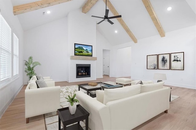 living room featuring ceiling fan, light hardwood / wood-style flooring, high vaulted ceiling, and beamed ceiling