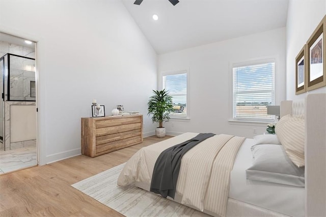 bedroom with ceiling fan, light hardwood / wood-style flooring, and vaulted ceiling