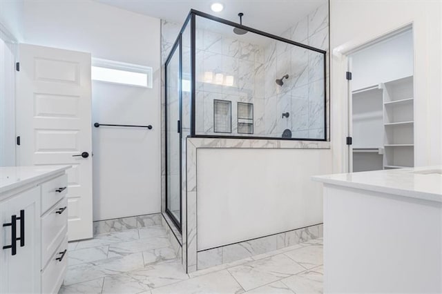 bathroom featuring vanity and a shower with shower door