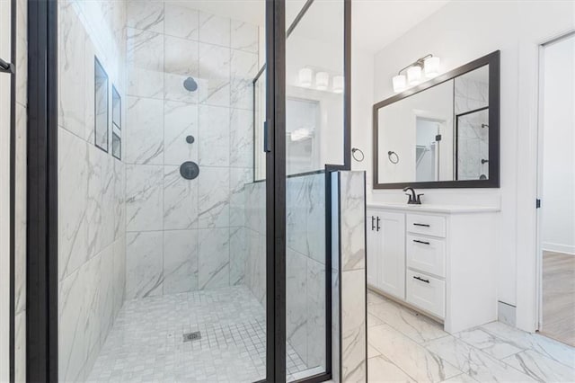 bathroom with a shower with door and vanity