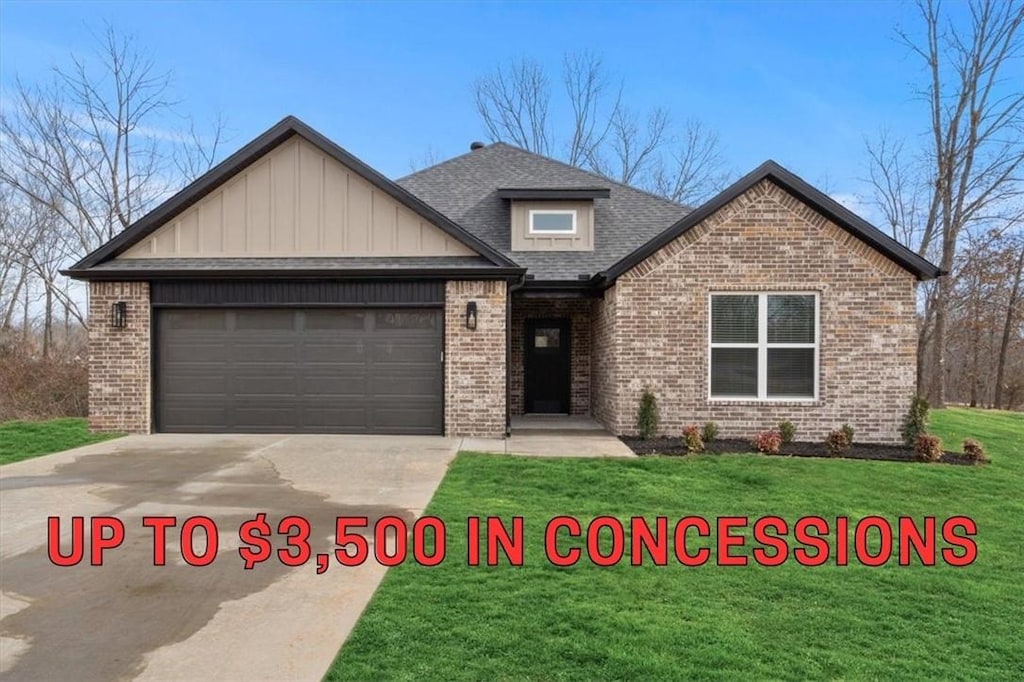 view of front of property featuring a garage and a front lawn