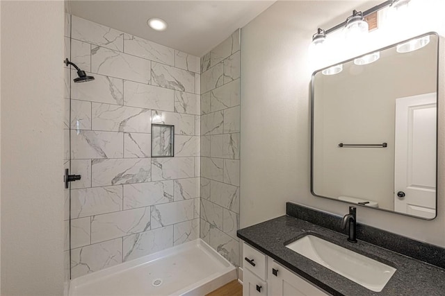 bathroom featuring a stall shower and vanity