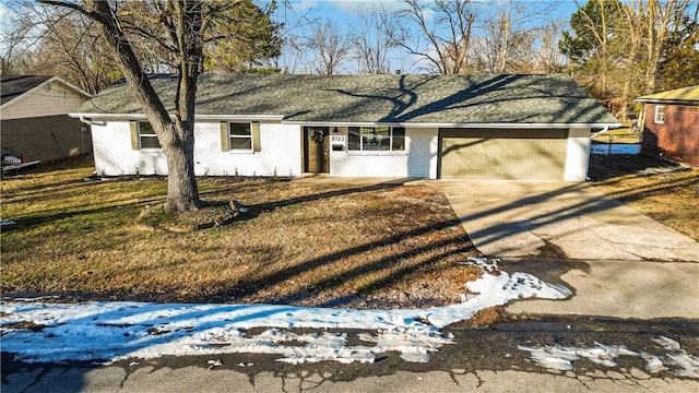 ranch-style house with a garage and a lawn