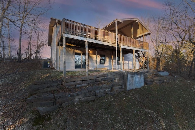 back of house featuring a deck and stairway