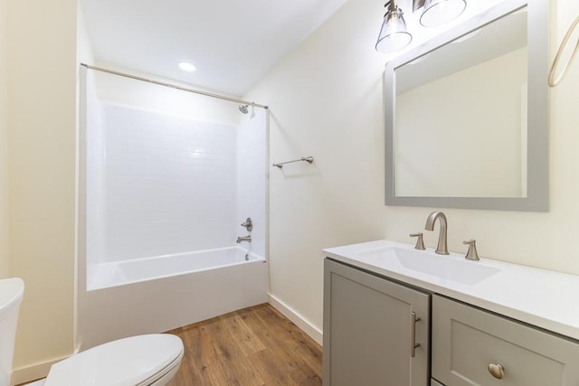 full bathroom with toilet, tub / shower combination, wood finished floors, and vanity