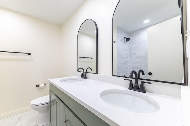 full bathroom with toilet, marble finish floor, a tile shower, and a sink