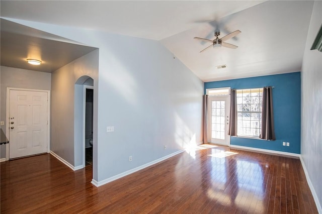 empty room with dark wood-type flooring, ceiling fan, and vaulted ceiling