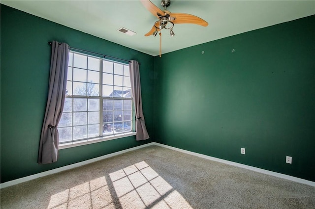 empty room with carpet, ceiling fan, and a healthy amount of sunlight