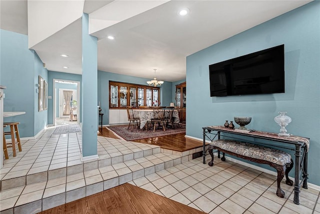 living room featuring light tile patterned floors and a notable chandelier