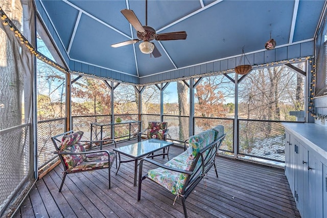 unfurnished sunroom with ceiling fan and lofted ceiling