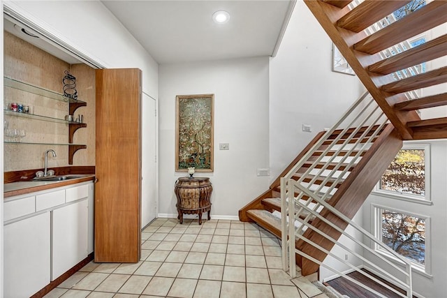 interior space with tile patterned flooring and wet bar