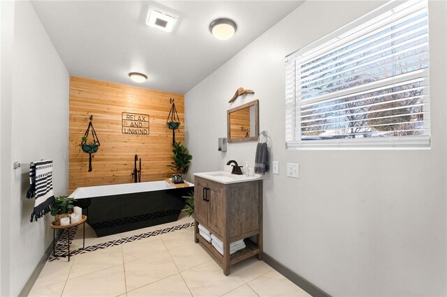 510 Chisholm Trl, Forsyth, MO 65653 - interior space with tile patterned floors, a tub to relax in, wood walls, and vanity