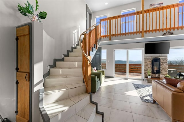 510 Chisholm Trl, Forsyth, MO 65653 - stairway featuring tile patterned flooring, a stone fireplace, and a healthy amount of sunlight