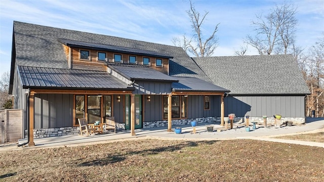 rear view of property featuring a patio area and a yard