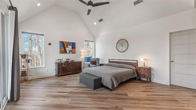 bedroom with ceiling fan, high vaulted ceiling, and light hardwood / wood-style floors