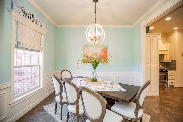 dining space featuring plenty of natural light, crown molding, and a chandelier