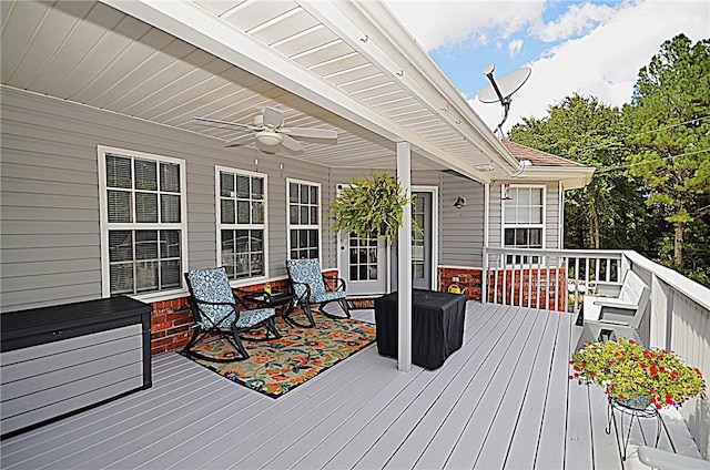 wooden deck featuring ceiling fan