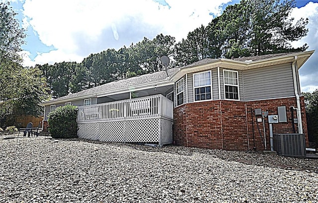 back of house with central AC unit