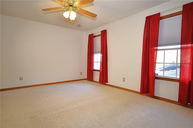 spare room with ceiling fan and carpet flooring