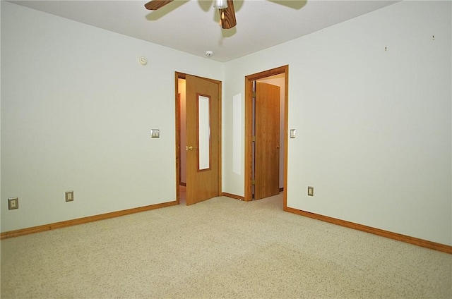 spare room featuring light carpet and ceiling fan