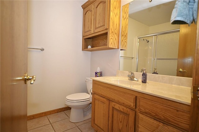 bathroom with toilet, a shower with door, tile patterned floors, and vanity