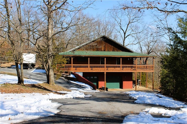 view of front facade with a deck and a garage