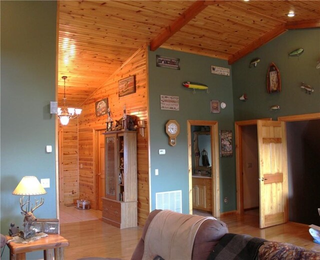 7 Viewpoint Dr, Eureka Springs, AR 72631 - living area with wood walls, wood ceiling, wood finished floors, high vaulted ceiling, and a chandelier