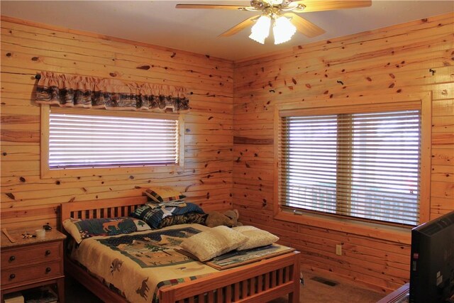 7 Viewpoint Dr, Eureka Springs, AR 72631 - bedroom featuring wood walls, multiple windows, and a ceiling fan