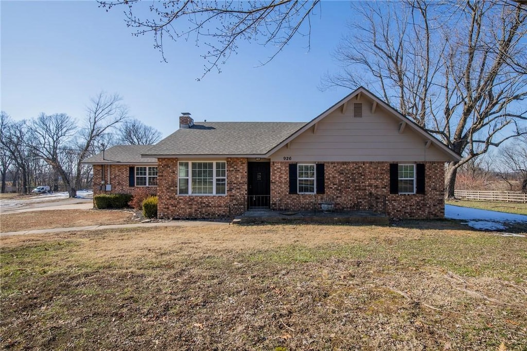 ranch-style home with a front lawn