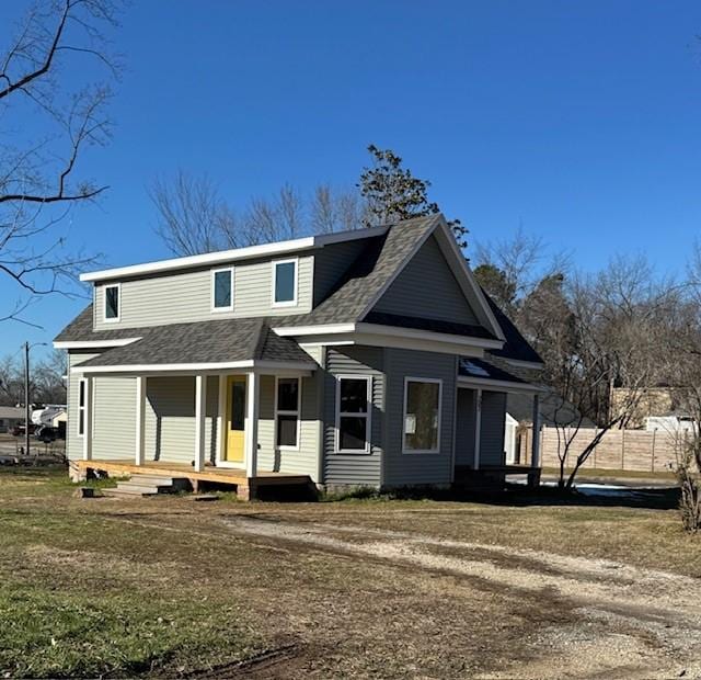 view of front of property featuring a porch and a shingled roof