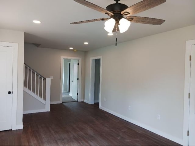 empty room featuring stairway, a ceiling fan, wood finished floors, baseboards, and recessed lighting