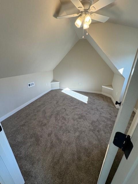 bonus room featuring visible vents, carpet floors, baseboards, and vaulted ceiling